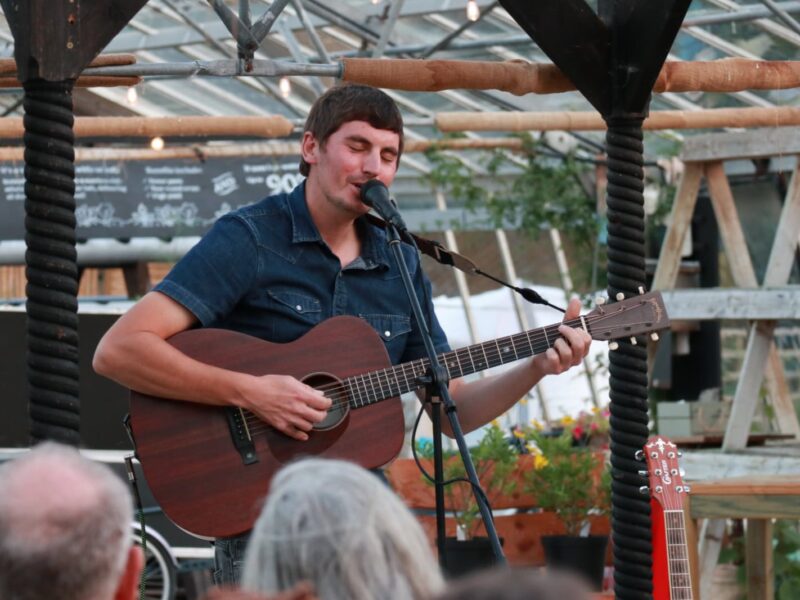 Tom Cole playing in the greenhouse at Babylon