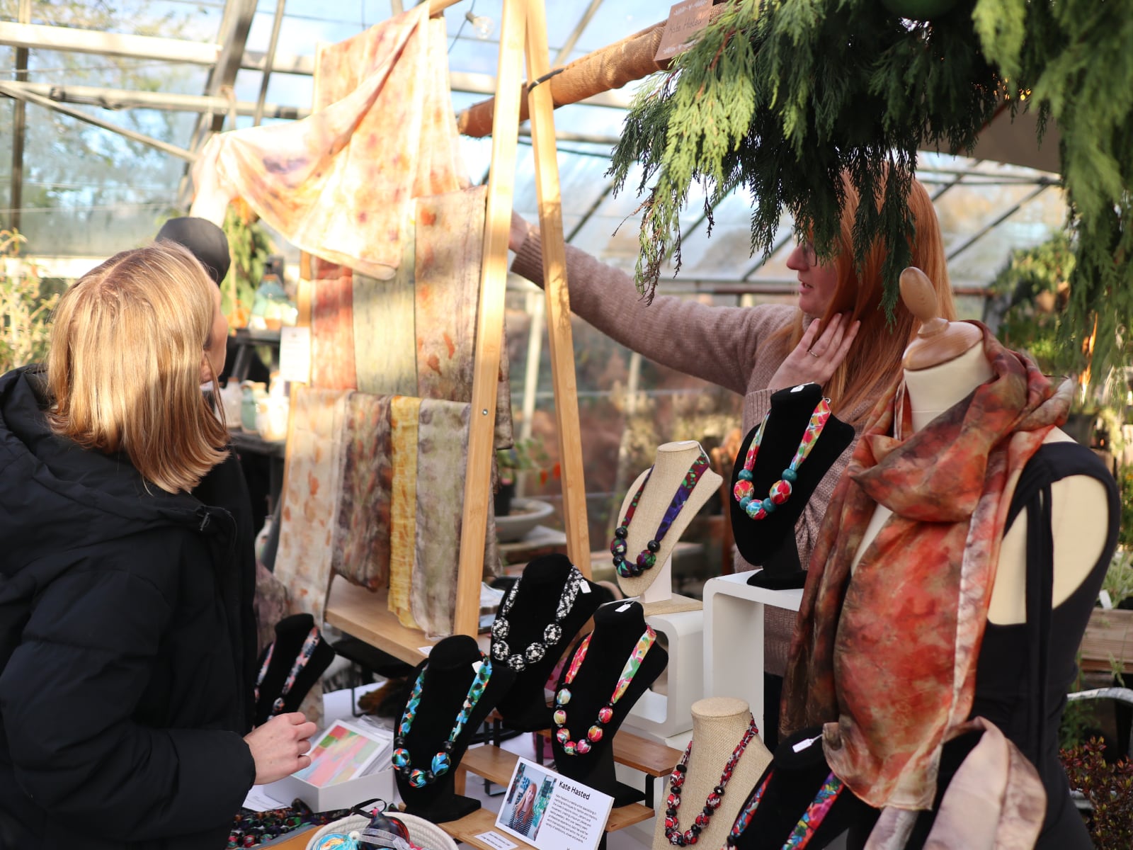 Woman looking at scarves on one of the stalls.
