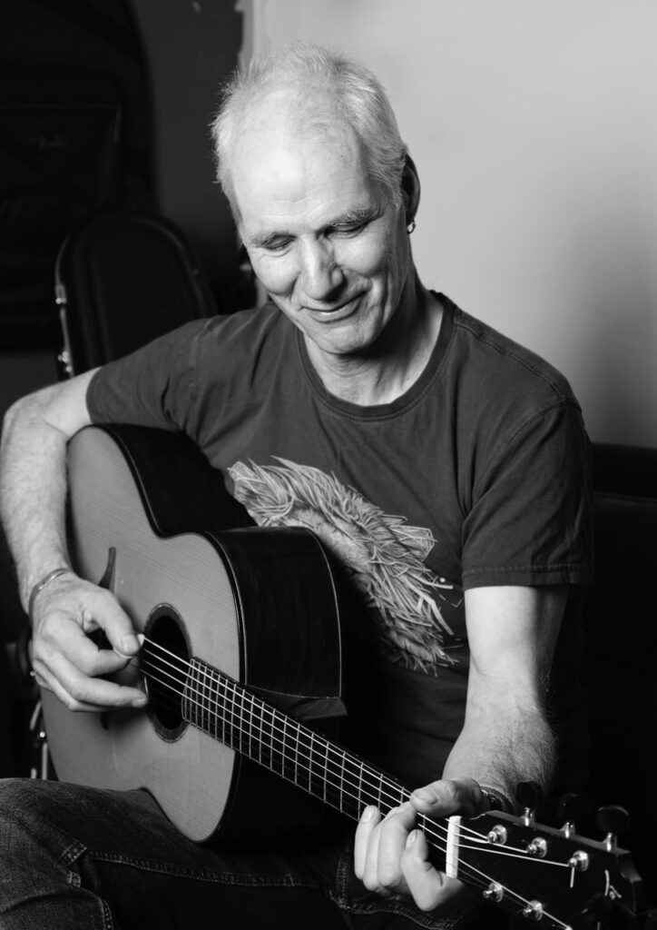 Martyn Travis playing his guitar.