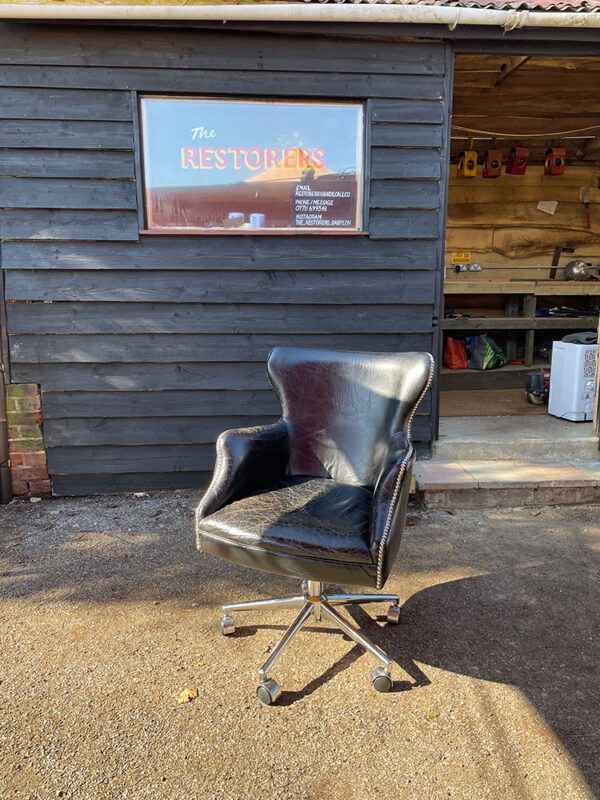 Leather office chair with repaired metal base.