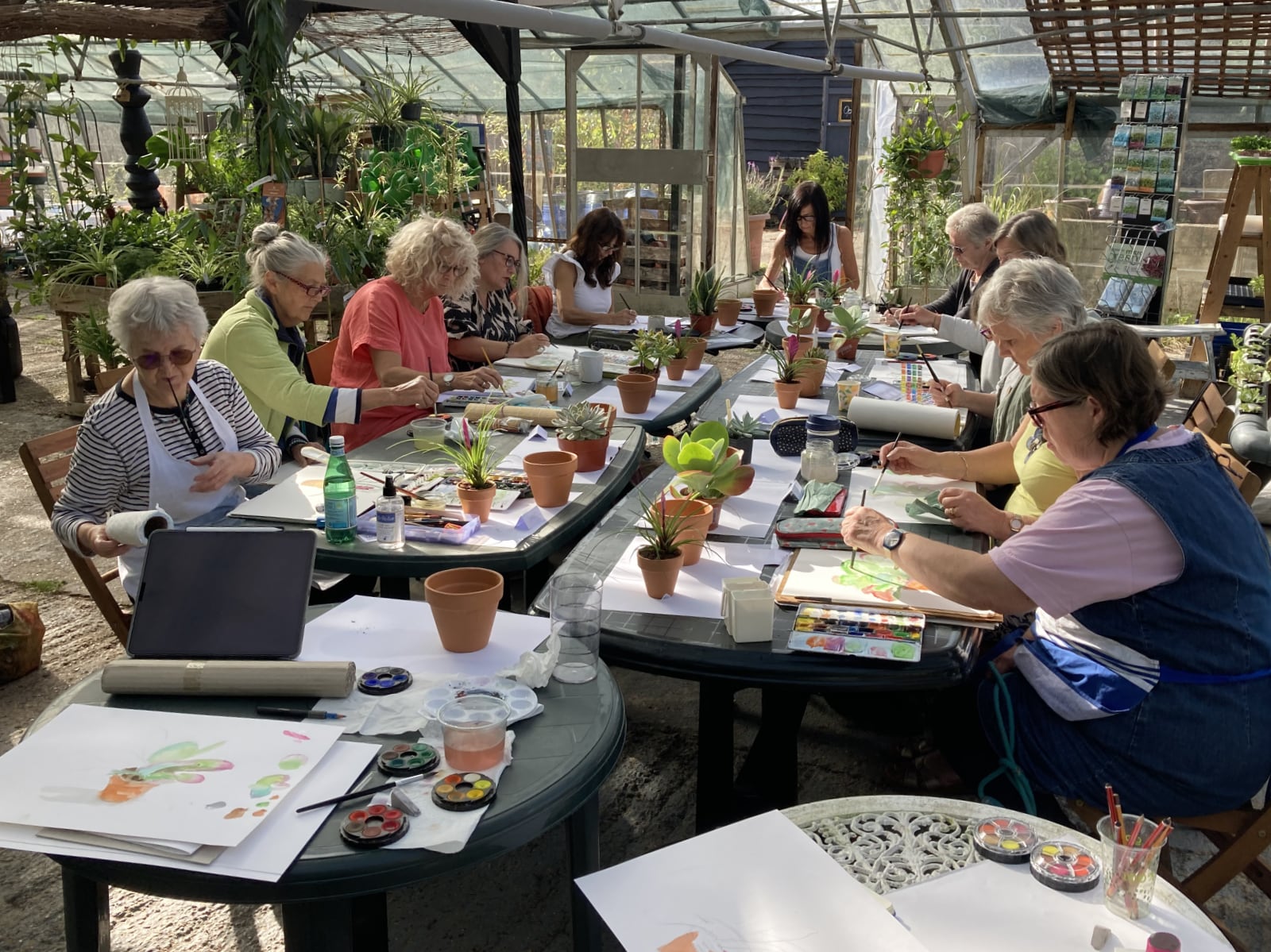 Students at Jan Moffitt's watercolour class, painting together in our greenhouse.