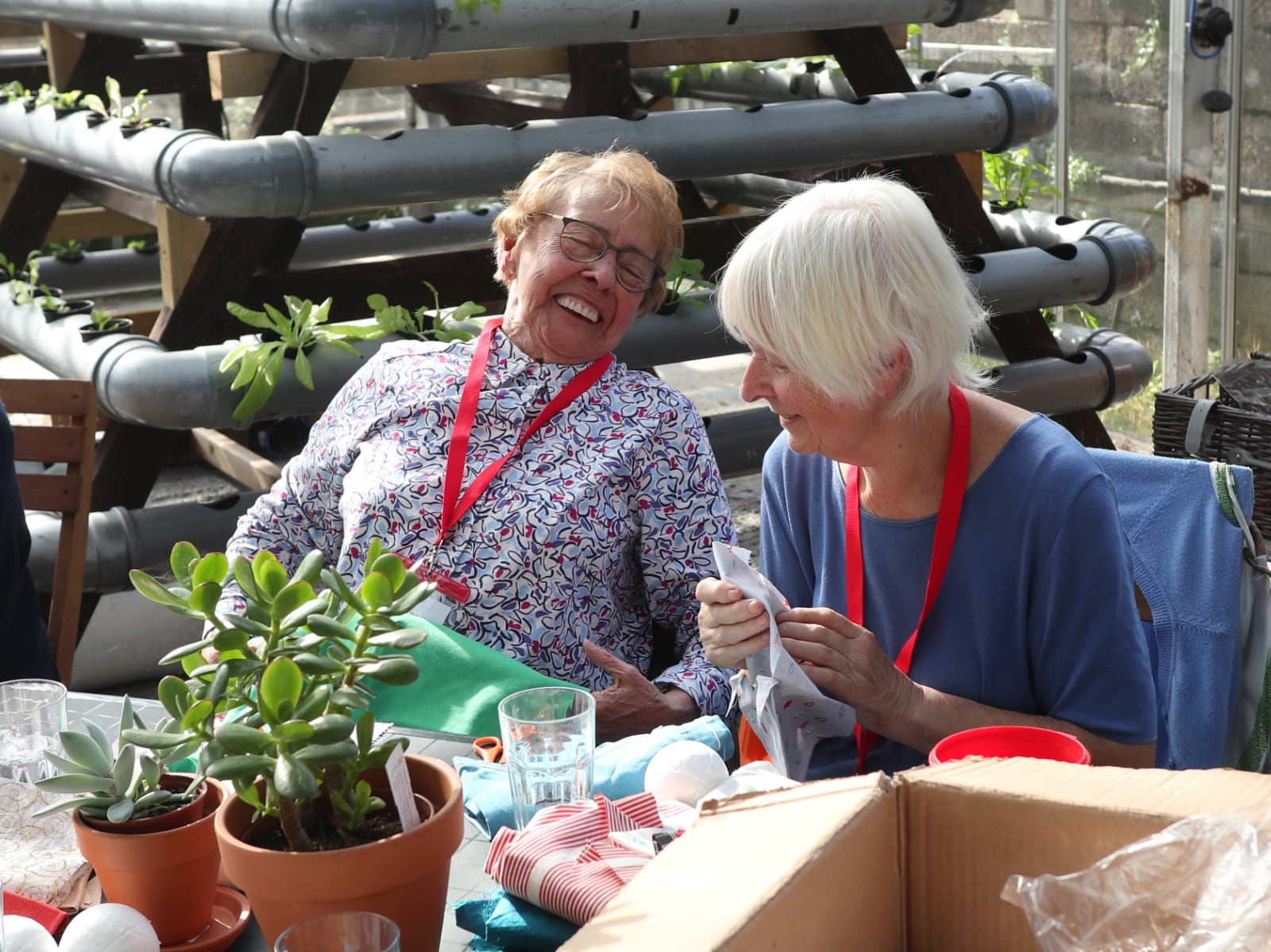 Two women from the Young at Heart community group smiling.