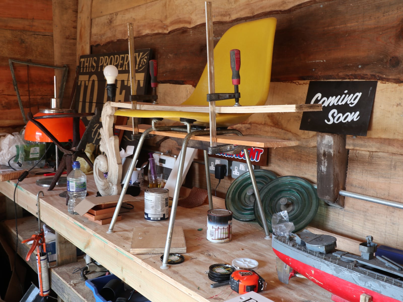 A yellow chair being repaired in The Restorers workshop.