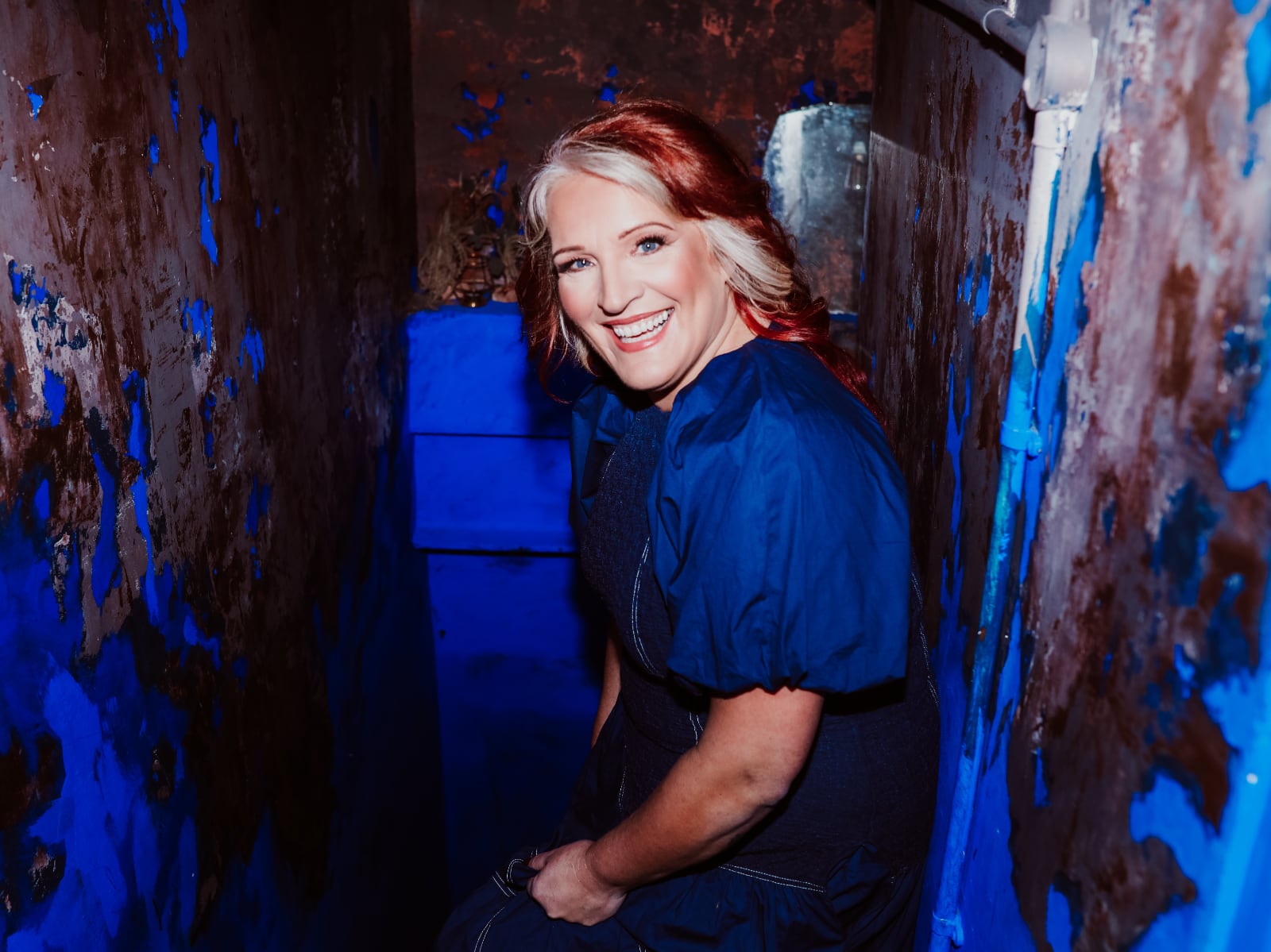 Anna Howie dressed in blue and smiling!