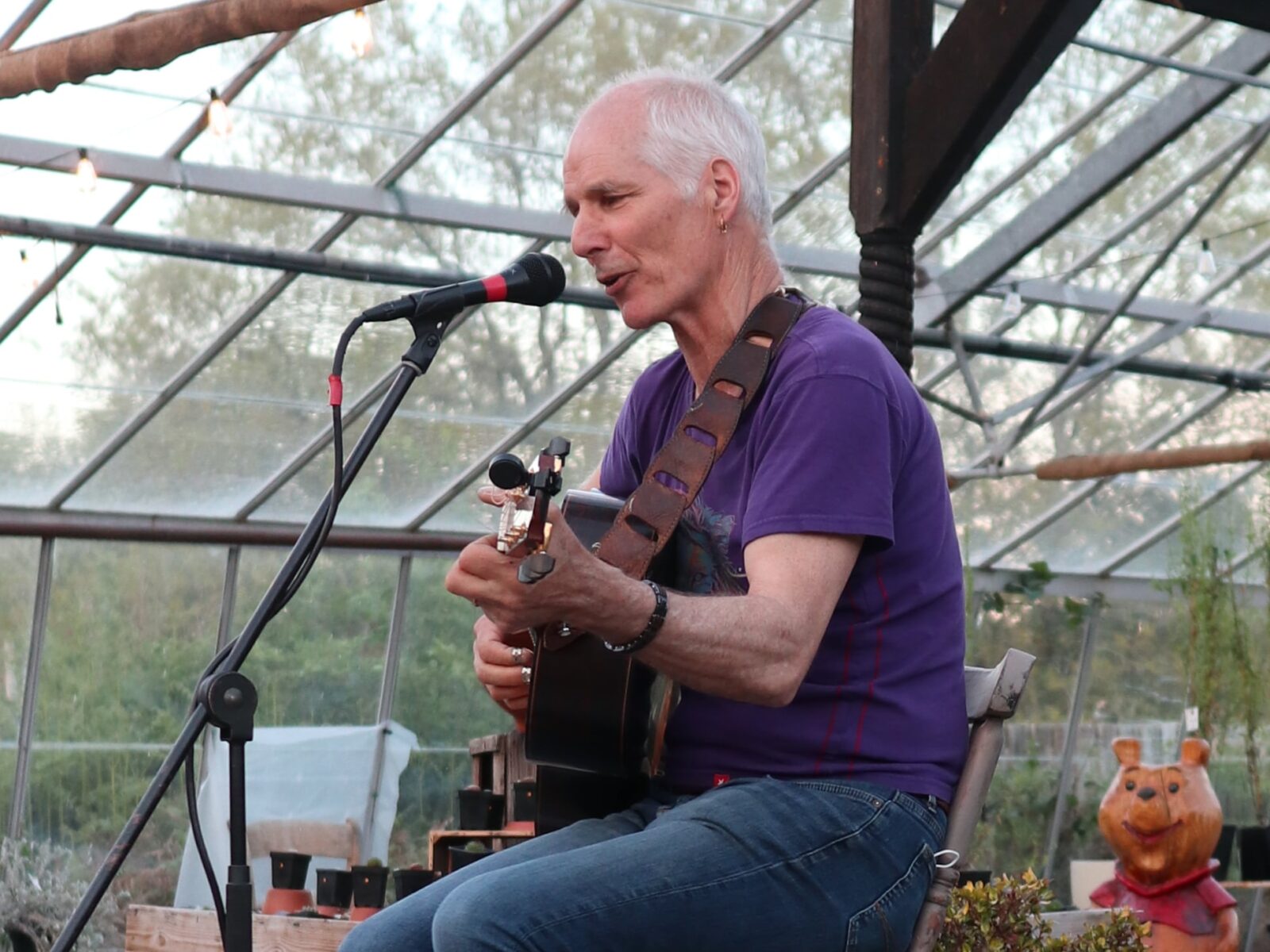 Martyn Travis singing in the greenhouse.