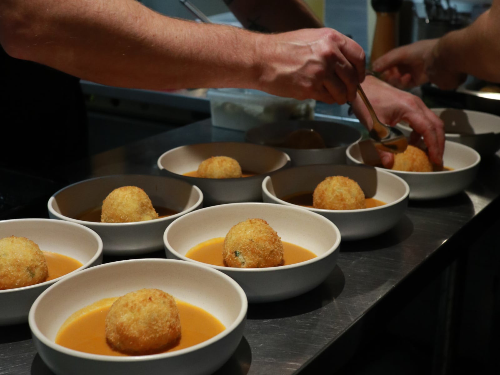 Chefs plating up dishes at The Secret Kitchen.